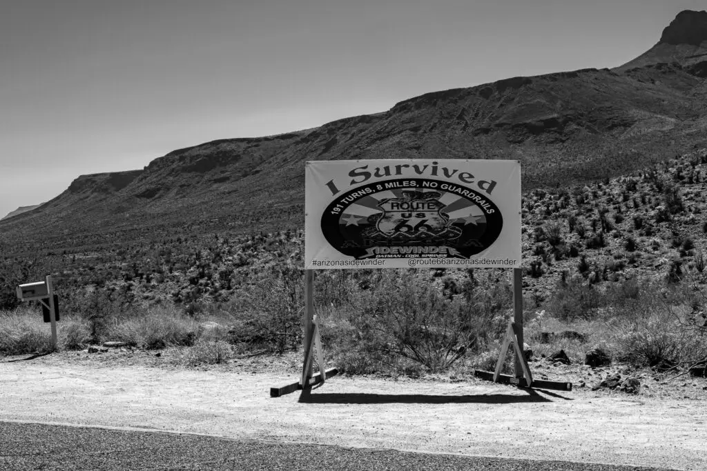 Billboard sign I survived 191 turns 8 miles no guard rails Route 66 Arizona