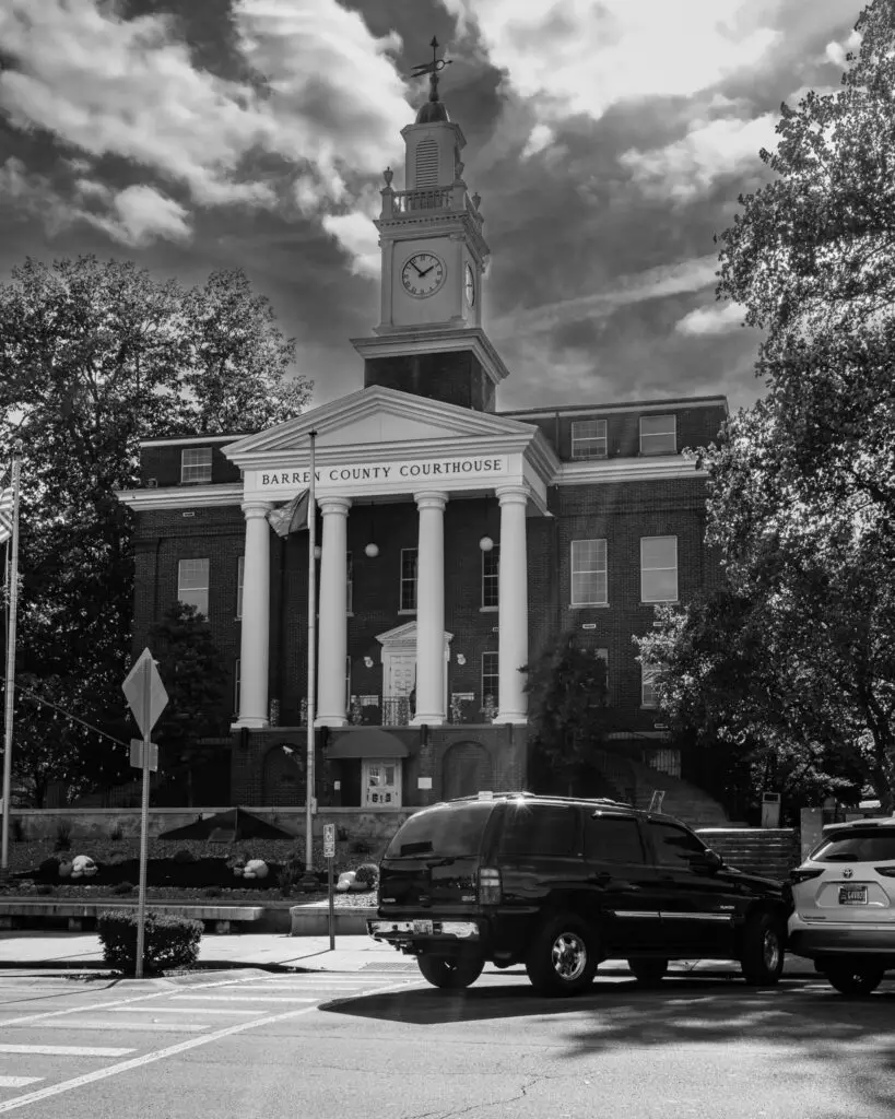 Color photo of the historic Barren County Courthouse at the center of Glasgow, Kentucky’s public square, with its clock tower and stone detailing.